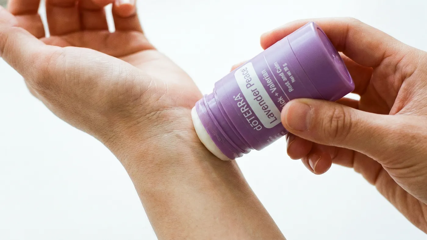 Applying the dōTERRA Lavender Peace Stick + Valerian to the inside of the wrist